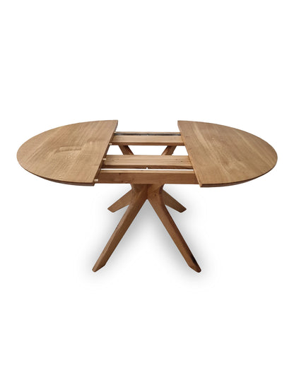 Vera extendable round dining table in clear oak with solid wood spider legs, natural finish, middle extension, 3cm thick top, handcrafted from FSC-certified solid oak, customizable size, color, and edge.