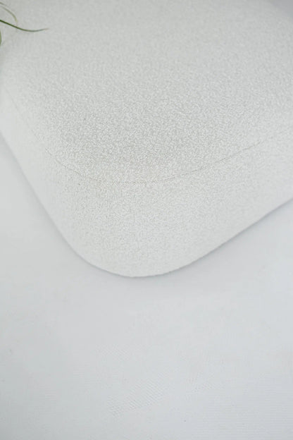 White textured boucle sofa corner on a light gray background